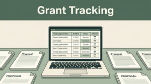 An open laptop showing a grant tracking dashboard next to proposal documents.