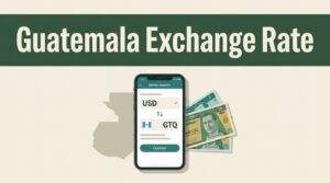 A smartphone showing a money transfer conversion rate next to Guatemalan banknotes.