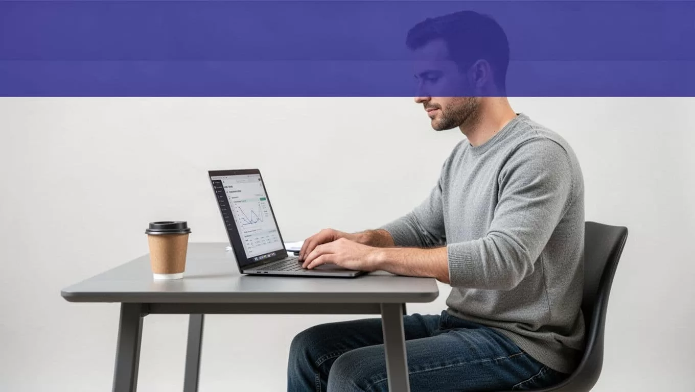 A seated manager reviews abstract commission charts on a laptop beside a coffee cup.