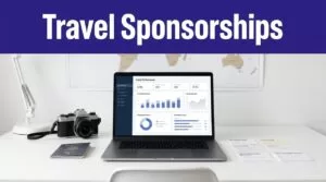 A laptop, camera, passport, and travel notes arranged beneath a Travel Sponsorships banner.