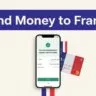 A smartphone confirms a money transfer beside a French bank card.