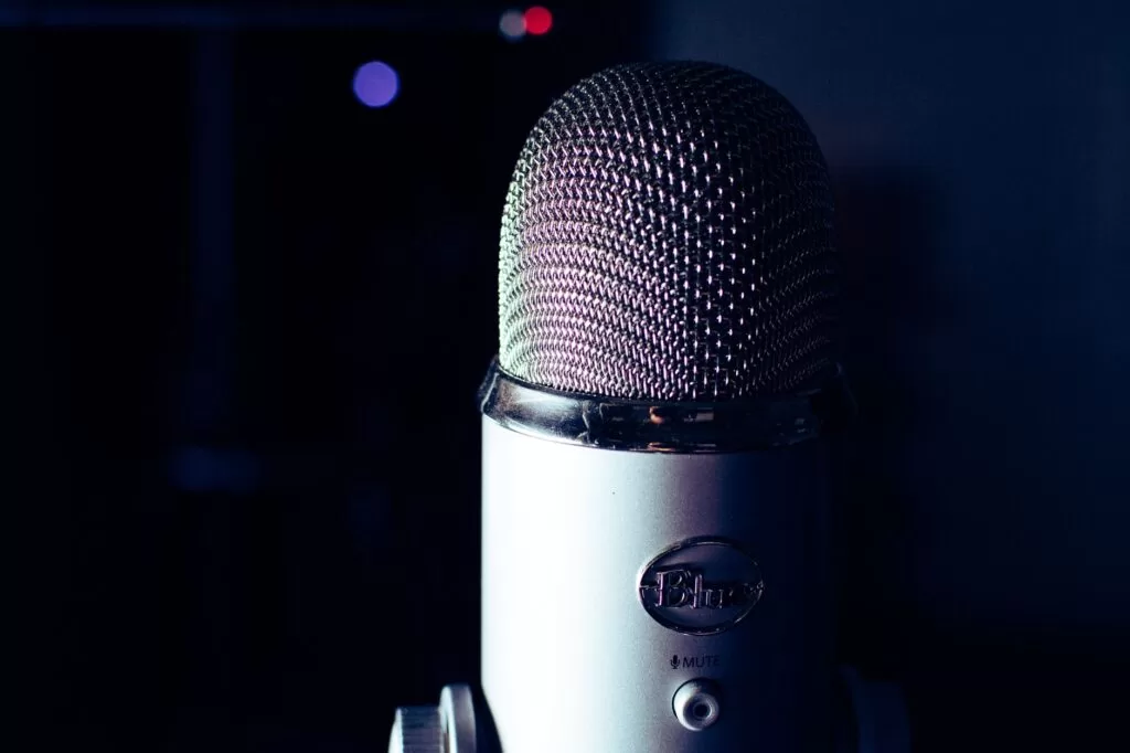 Condenser microphone in a dimly lit recording studio