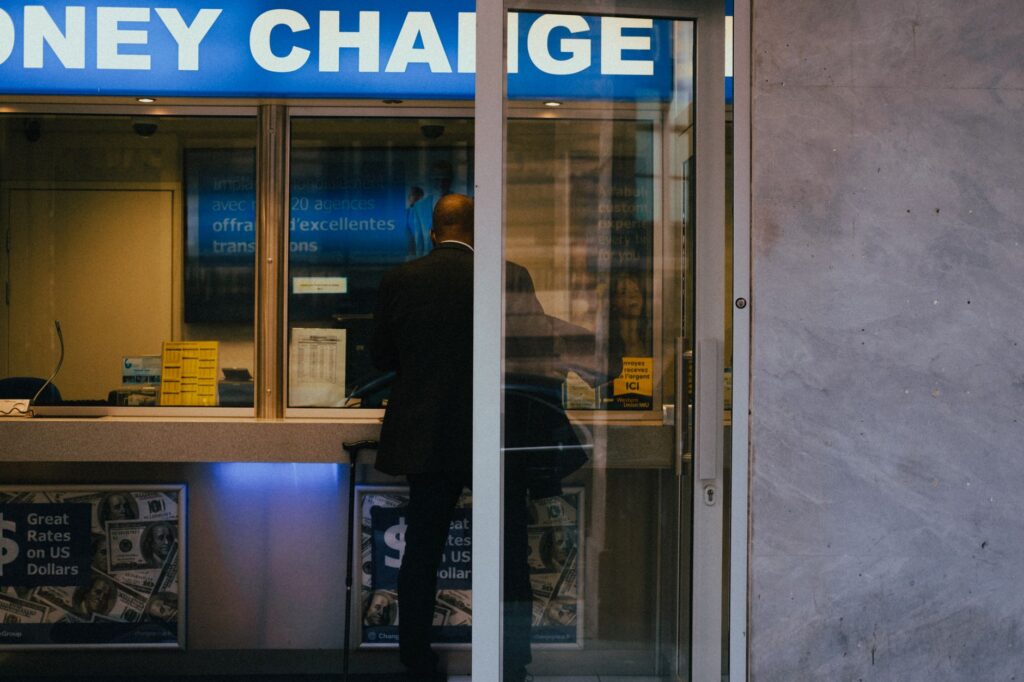 Man at a currency exchange office window