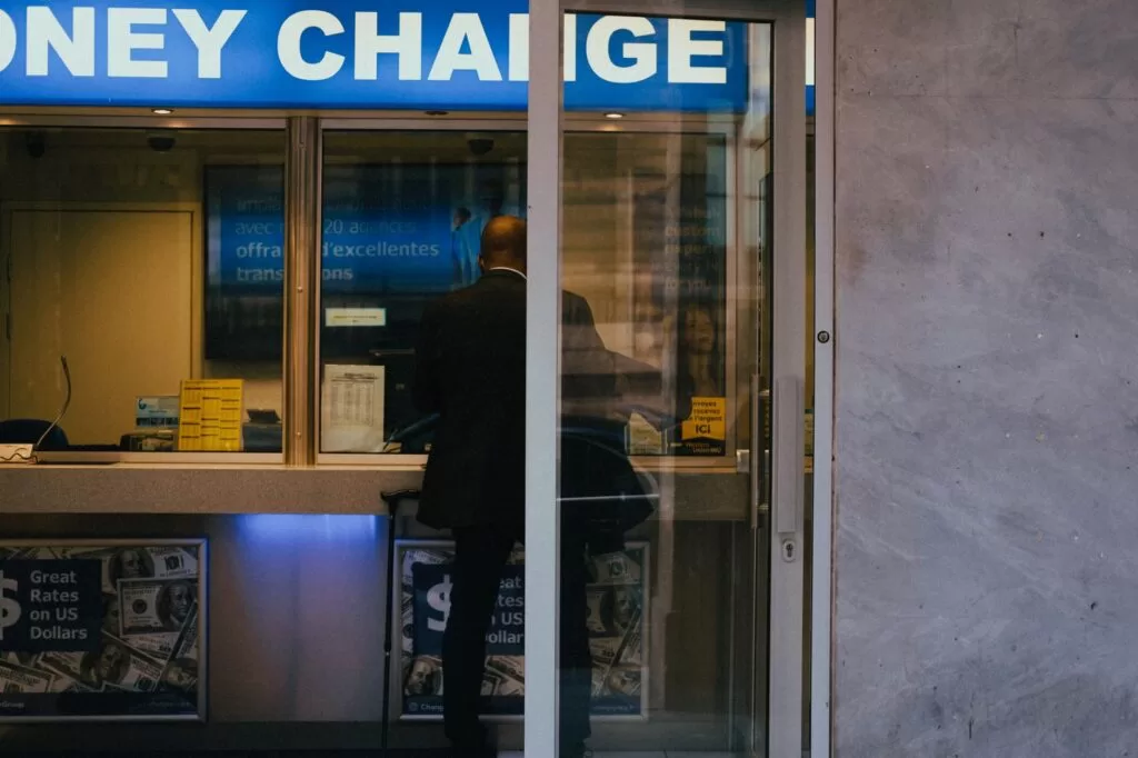 Man at a currency exchange office window